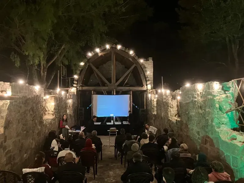 Cine Mosteiro screening at night by the stone arch