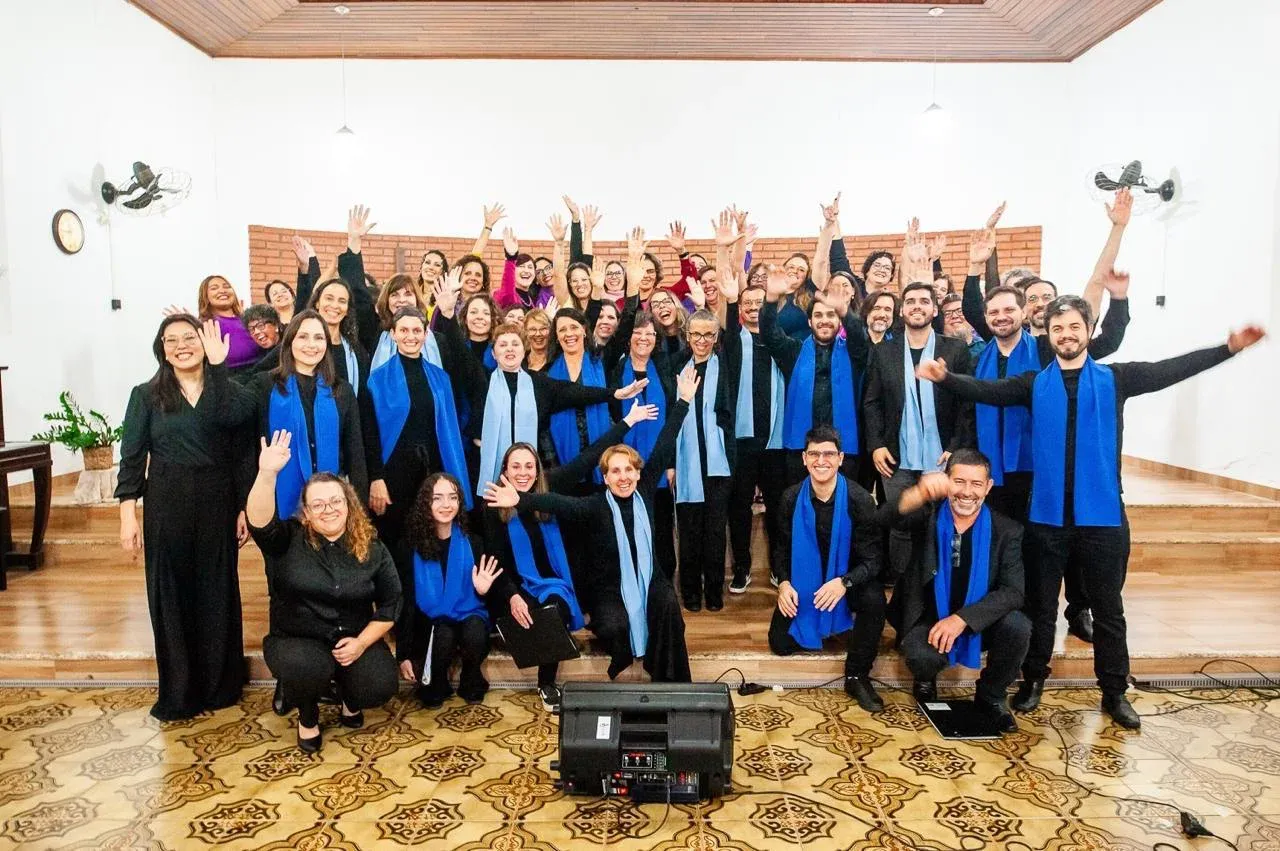 The CEC choir celebrating, arms raised