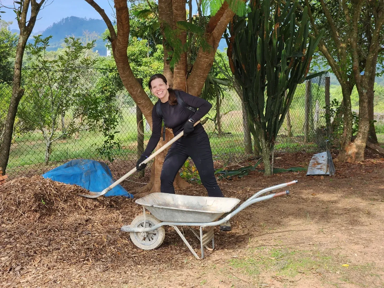 Member filling a wheelbarrow during a work day