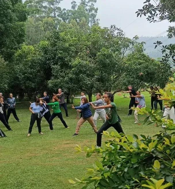 Group doing an outdoor practice on the monastery lawn