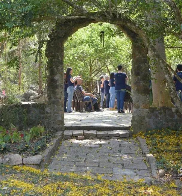 People gathered outdoors, seen through a stone arch